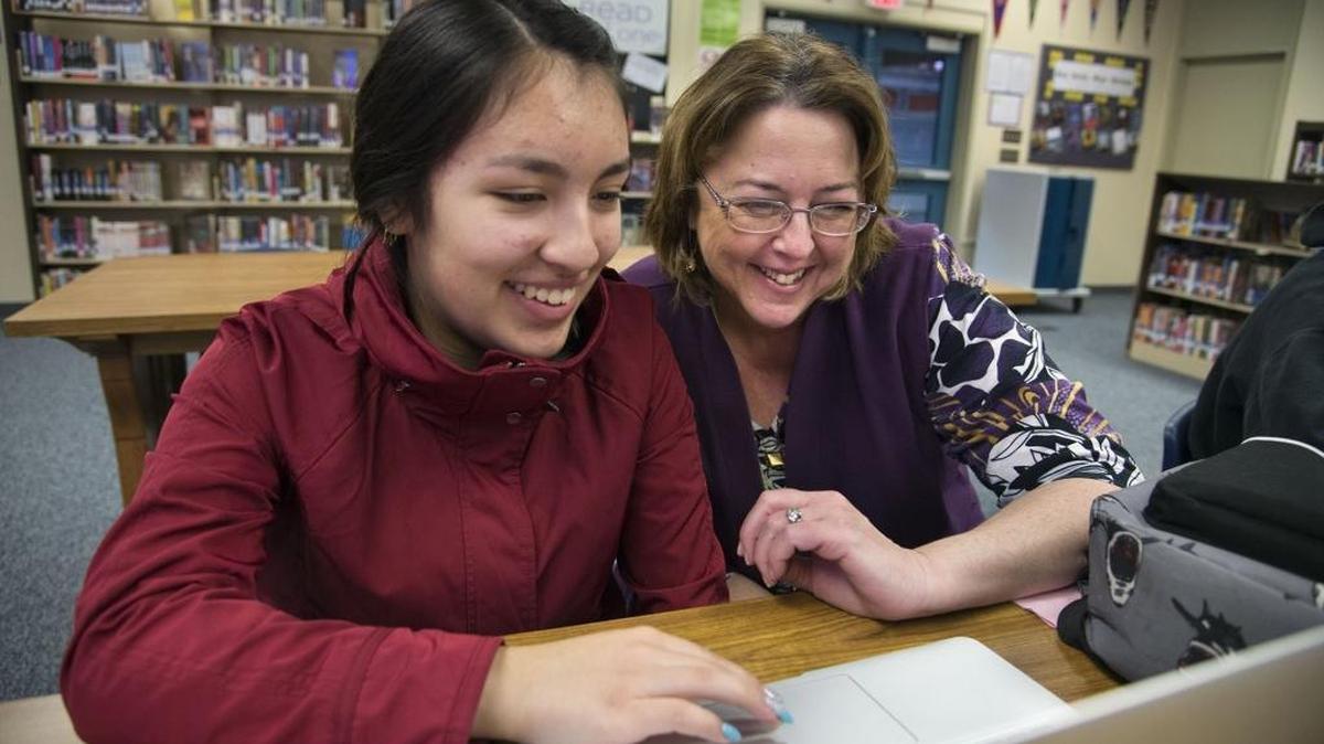 Audrey Orozco, 16, who will be among the first students to graduate from Kit Carson as a high school, works with art teacher Christine Helweh during class on Friday, February 3, 2017 in Sacramento, Calif.