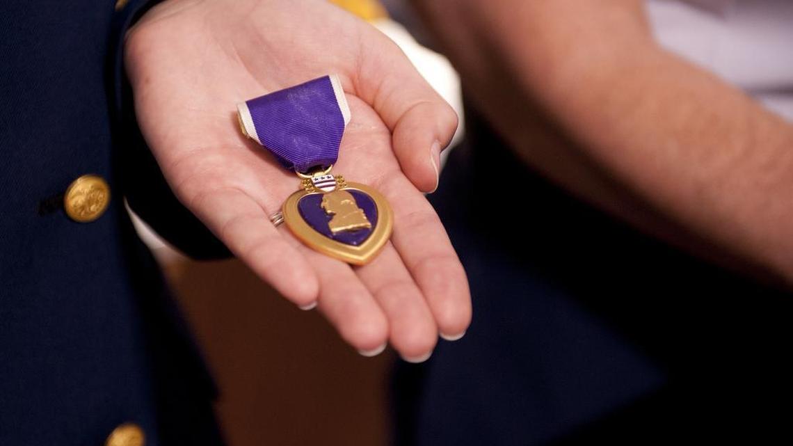 U.S. Coast Guard Capt. Charles Satterlee was awarded his Purple Heart medal at the U.S. Coast Guard Museum in New London, Conn., Saturday, May 12, 2012. Satterlee received the award for injuries he sustained, and members of his family received the medal on his behalf.