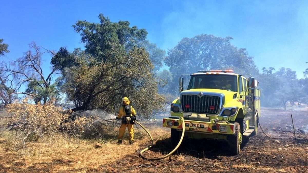 Crews work Friday morning to contain the Skyway fire east of Chico.