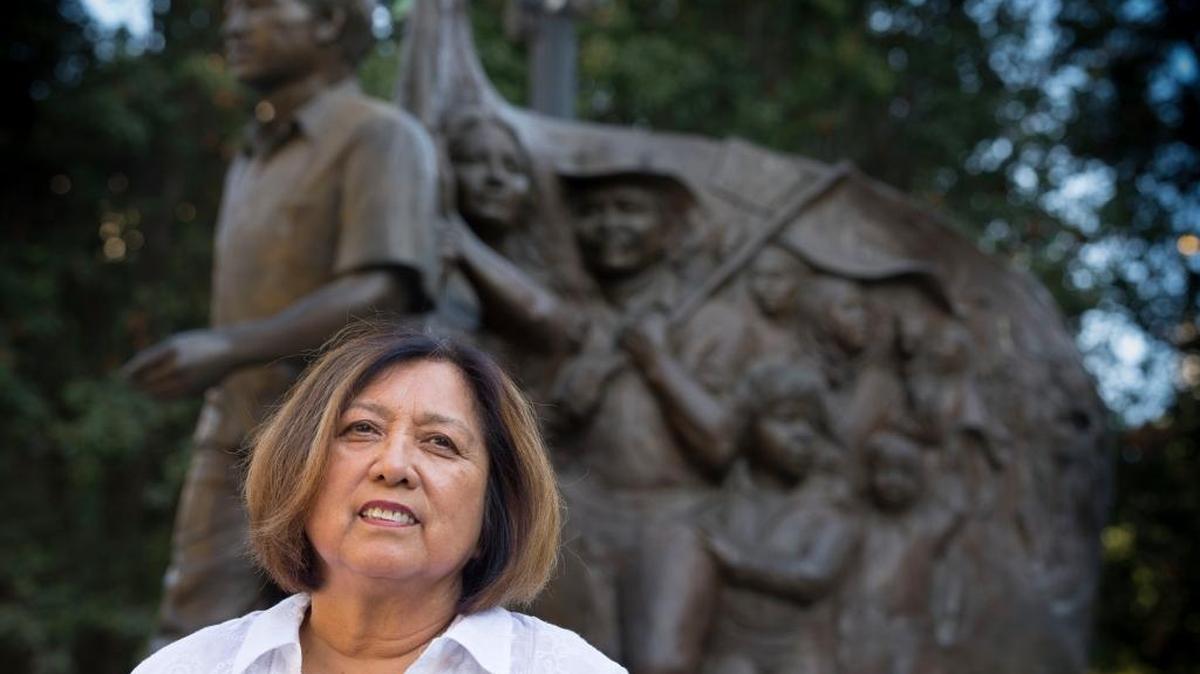 
Grape strike veteran Lorraine Agtang stands in front of the Cesar Chavez monument in Sacramento that includes her likeness. 
