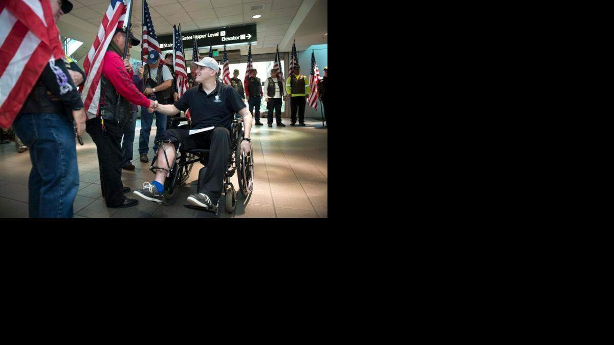 
Will Hoover was one of eight American soldiers shot while protecting a delegation touring Camp Qargha's Marshal Fahim National Defense University in Kabul, Afghanistan. U.S. Army Maj. Gen. Harold Greene was killed in that attack. Here, Hoover receives a hero’s welcome from the Patriot Guard as he returns to Sacramento for the first time on Friday, Nov. 14, 2014.
