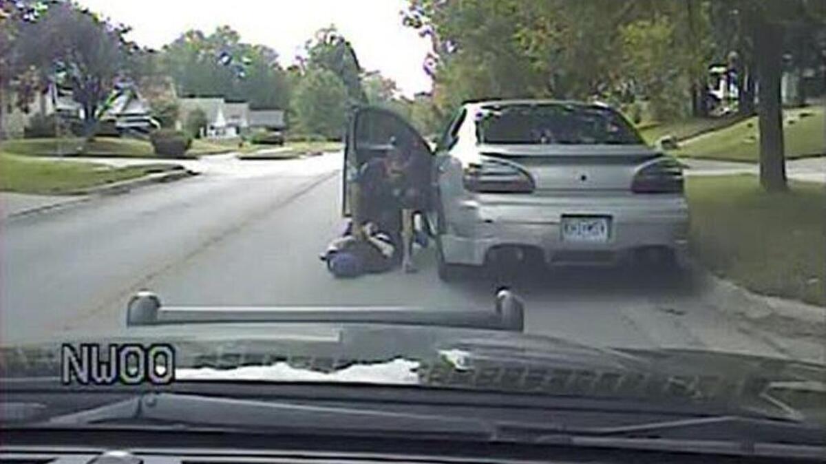 An Independence, Mo., police officer pins a teen to the pavement after using a stun gun and handcuffs to subdue the 17-year-old, who subsequently went into cardiac arrest.
