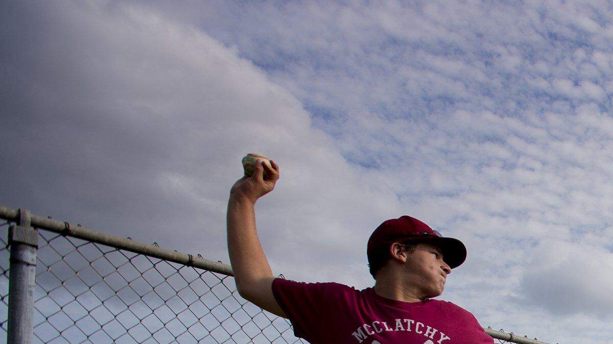 Ty Hansen watches his son, pitcher, Thomas Hansen throw in the bullpen at McClatchy High School in Sacramento in 2015.