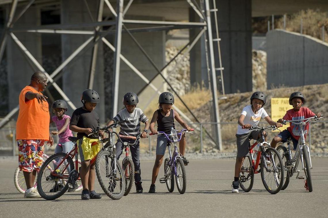 Executive Director of Always Knocking, Greg King, far left, gets a group of kids ready for a bike ride at the Nimbus Fish Hatchery in Rancho Cordova on Tuesday. The American River Parkway Foundation is focusing this summer on getting underprivileged urban children out to the river to hike, bike and meditate.
