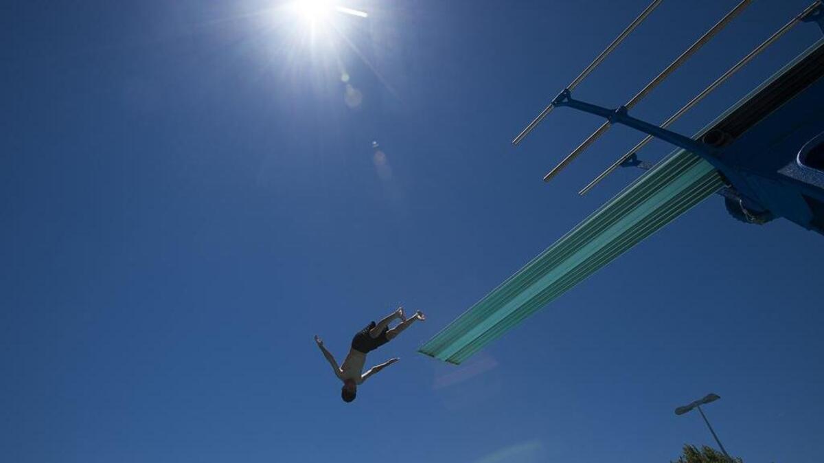 A young man dives from the high diving board at the Barbara Morse Wackford Community & Aquatic Complex on Sunday in Elk Grove.