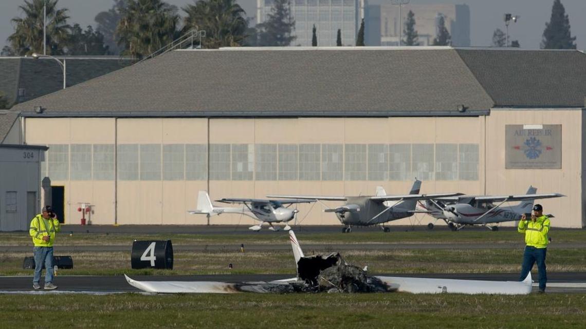 Investigators examine the wreckage of a small airplane that crashed shortly after takeoff Saturday at Sacramento Executive Airport.