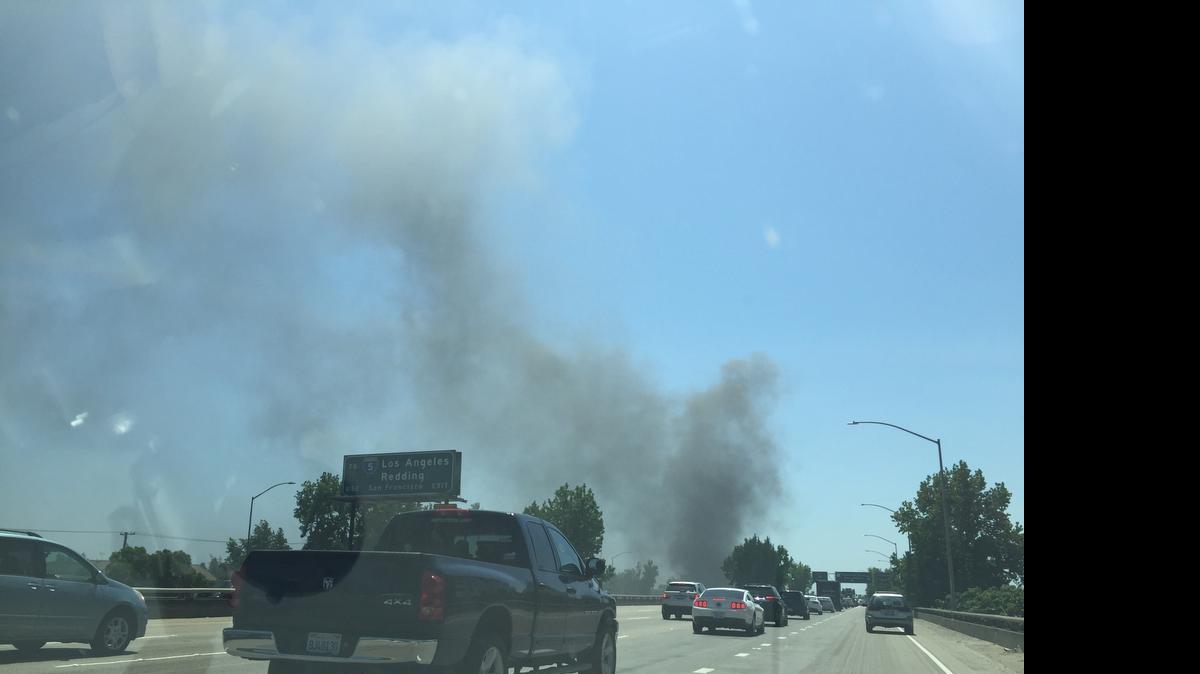 
Plumes of dark smoke coming from a reported vehicle fire on I-80 E near P Street on Saturday
