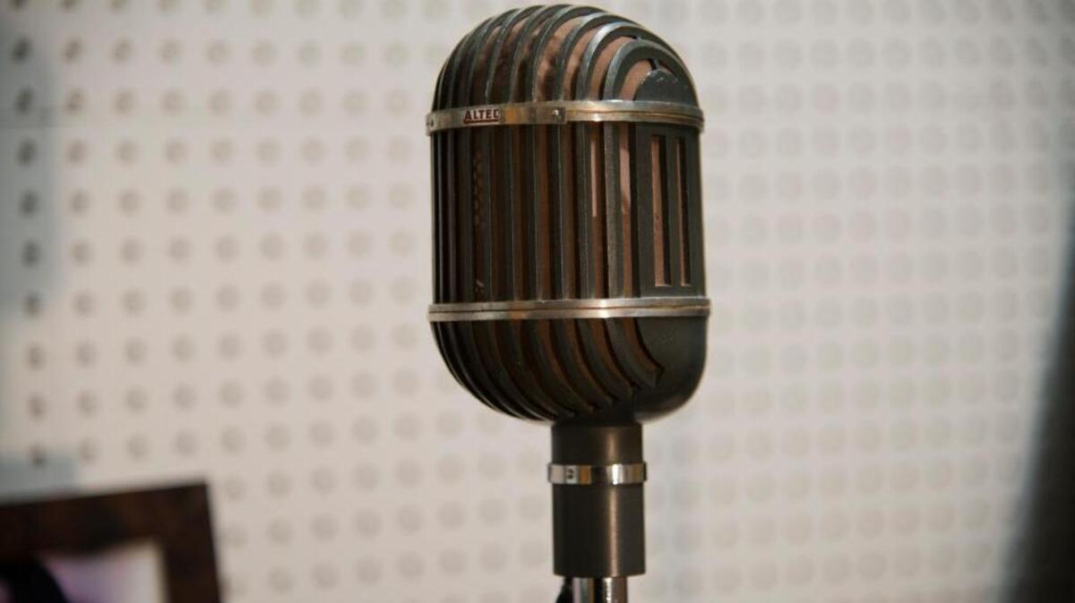 FILE --Matias Bombal, a local film critic and former theater manager with a vintage microphone that might have been used by Judy Garland now in his vintage radio studio set in his garage at his home in Sacramento, Calif. Sacramento may soon get a French-language radio station.