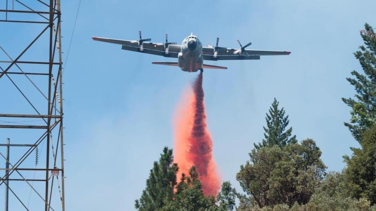 An air tanker battling the Lowell fire drops fire retardant July 26 in Nevada County. McClellan is being promoted as a possible central base for aerial firefighting for the Western region.
