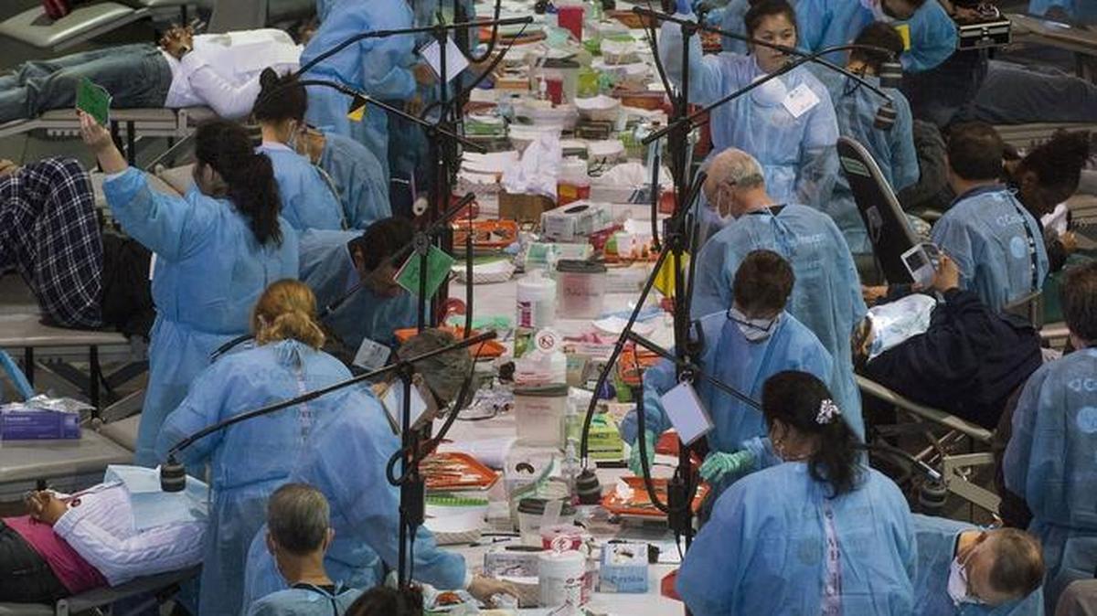 Rows of dental volunteers work on patients during a CDA Cares Dental event at CalExpo in Sacramento on Friday, March 27, 2015. This weekend’s event is run by California CareForce.