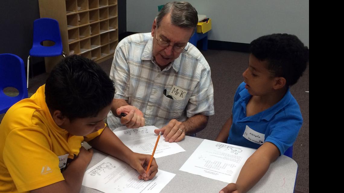 
David Kiesewetter tutors two Iraqi children at the First Covenant Church of Sacramento.
