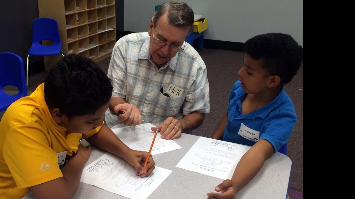 
David Kiesewetter tutors two Iraqi children at the First Covenant Church of Sacramento.
