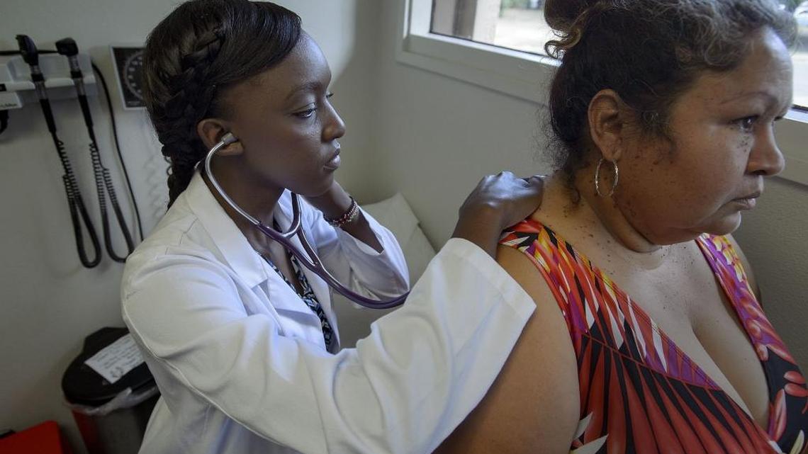 UC Davis second-year medical student Alisha Othieno, left, examines patient Maricella Moran at the Imani Clinic in Sacramento on Saturday. Imani Clinic is a UC Davis medical student-run clinic that helps folks in the south Sacramento area get some basic services. Medi-Cal patients hoping to get primary care services sometimes face long wait times at hospitals or centers, so this student-run clinic helps individuals who fall between the cracks.