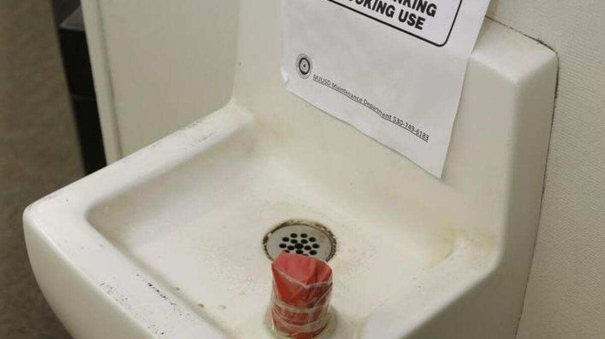 Tape covers the spout and a sign warns students not to use this water fountain at Foothill Intermediate School on Wednesday, April 6, 2016 in Loma Rica, Calif. Many public water systems in California serving schools, parks, prisons and neighborhoods have found lead at levels unsafe for drinking.