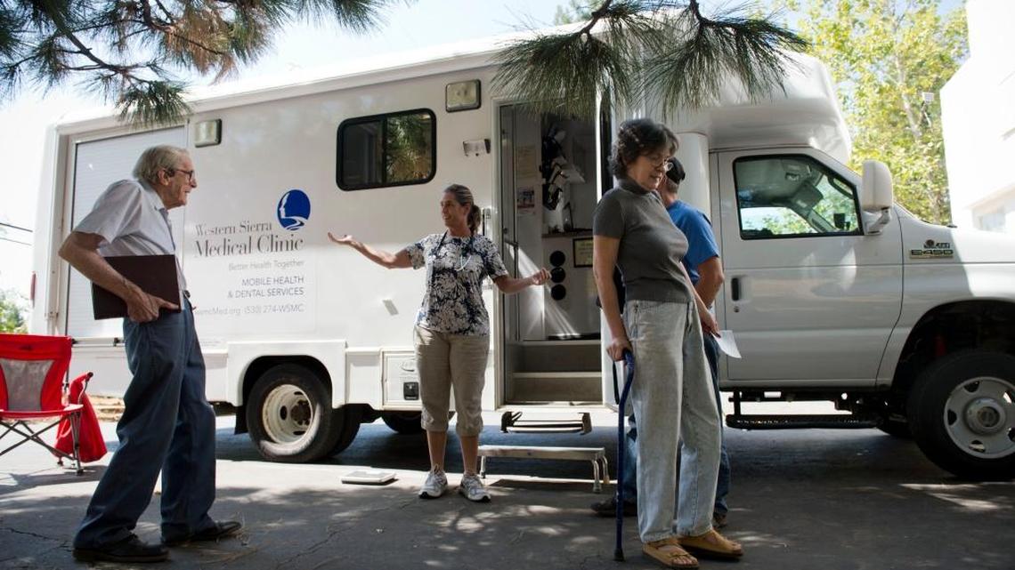 Glenn and Janelle Ransom of Brownsville, right, leave after their appointment as Dr. Celia Sutton-Pado welcomes her next patient, Leland Pauly, 90, who has lived in Camptonville his whole life. On the first Tuesday of every month, the Western Sierra Medical group sends a mobile health clinic to the community resource center in Camptonville. The shortage of rural health care providers is exacerbated as more and more people enroll for coverage after the Affordable Care Act.