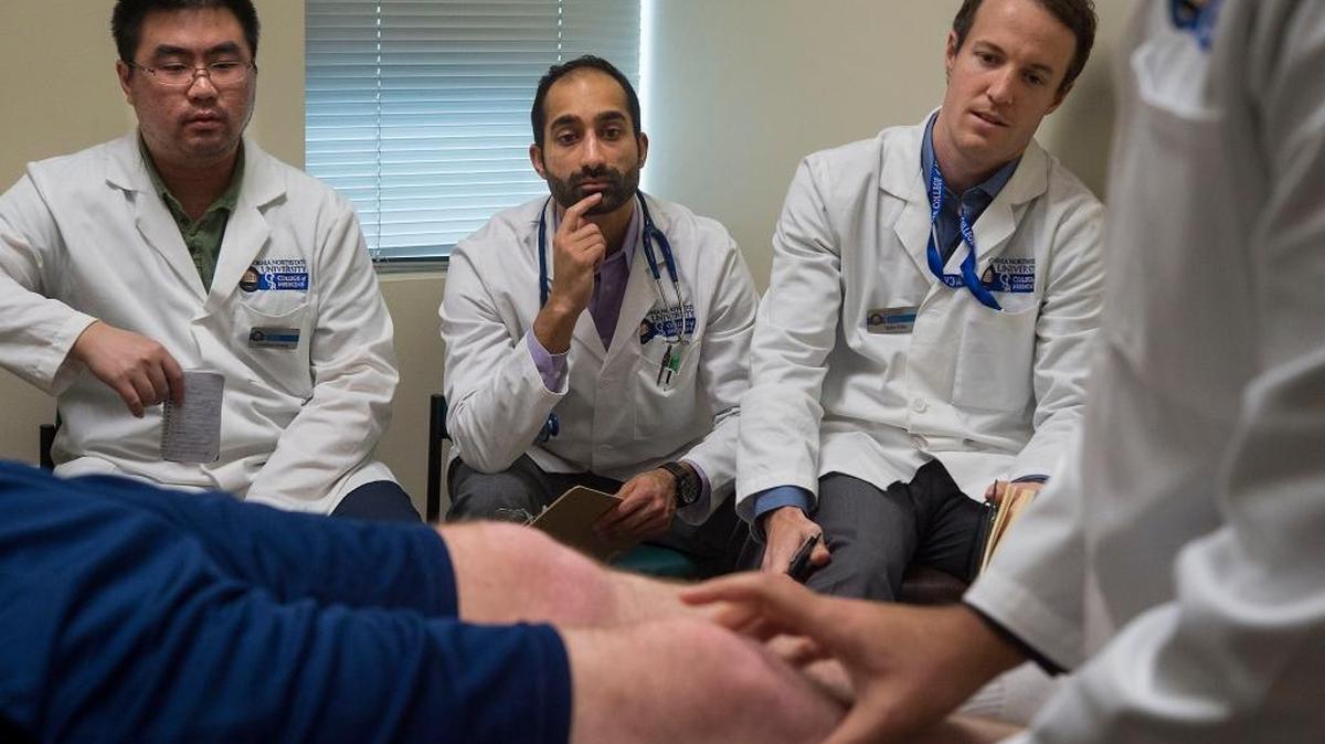 Medical students Jonathan Huang, left, Zain Lalani, and Tyler Ellis observe a demonstration on performing an orthopedic exam at California Northstate University College of Medicine in Elk Grove last month. These first-year medical students are attending the first for-profit medical school in the nation.