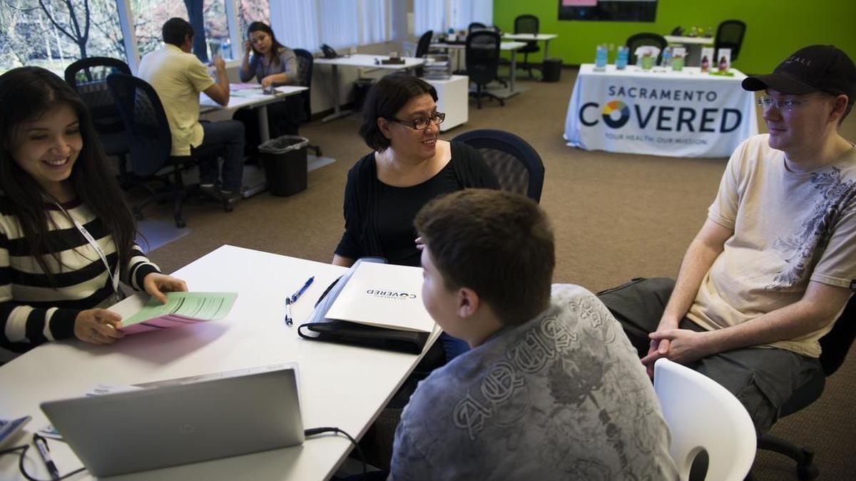 Manuela Osborn (second from left), Tanin Osborn (second from right) and Parrish Osborn (right) sign up for Covered California with help from Sacramento Covered on Feb. 14, 2015 in Sacramento, California.