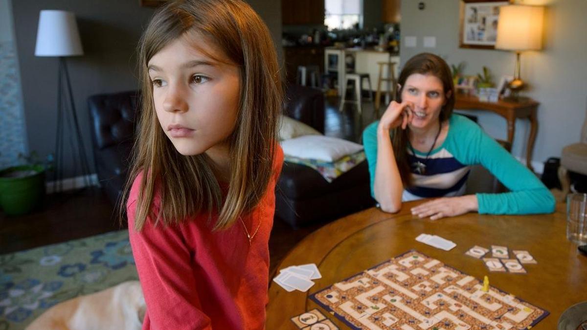 Riley Yeates 9, left, looks out towards the window while with her mother Kirsten Yeates at their West Sacramento home on Saturday, January 6, 2018. Riley didn’t receive an autism diagnosis until just after her third birthday. By then, she had become increasingly agitated and aggressive, her mother said.