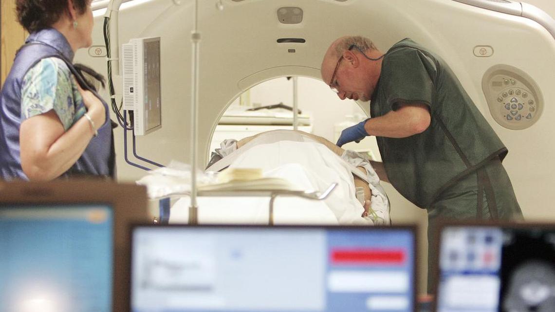 Dr. Steven Birnbaum works with a patient in a CT scanner at Southern New Hampshire Medical Center in Nashua, N.H. The American Cancer Society says there now is enough evidence to recommend screening certain older, heavy smokers for lung cancer. Research shows that screening these people can cut the risk of dying of lung cancer by 20 percent.