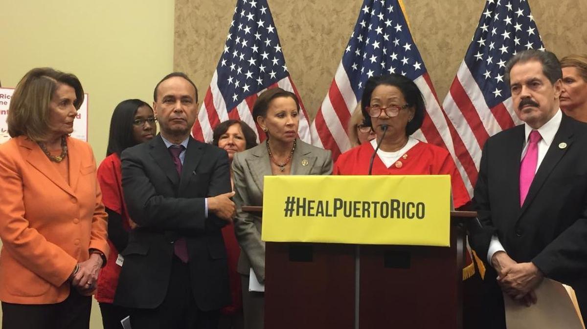At a news conference Thursday, Kaiser nurse Catherine Kennedy talks about the dire need she saw in Puerto Rico for food, water and dry shelter. Kennedy, at the lectern, is joined in the front row by, from left, Democratic Leader Nancy Pelosi of California; Rep. Luis V. Gutiérrez, D-Ill.; Rep. Nydia M. Velázquez, D-NY; and Rep. José E. Serrano, D-NY.