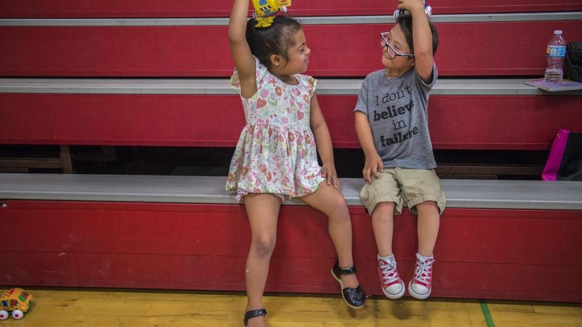 Dorian Gray, 5, right, mimics his best friend, Aliyah Mayfield, 6, both who have Down syndrome, as they play with toy cars Tuesday in Fair Oaks.