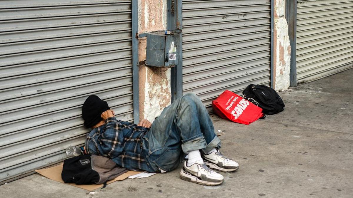 A man sleeps on Sixth Street near Skid Row on May 18, 2015.