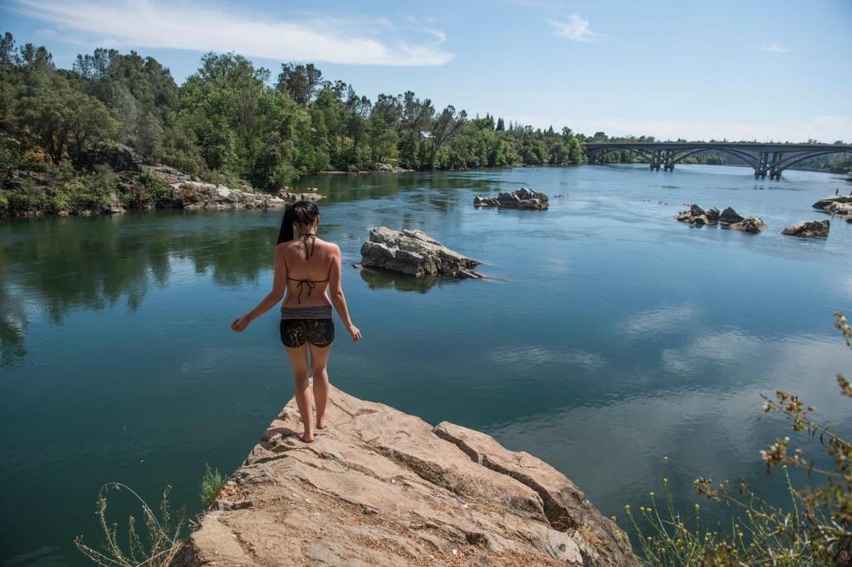 Katy Giudicessi, of Citrus Heights prepares to take a jump inside Lake Natoma in Folsom on Friday, June 3, 2016.