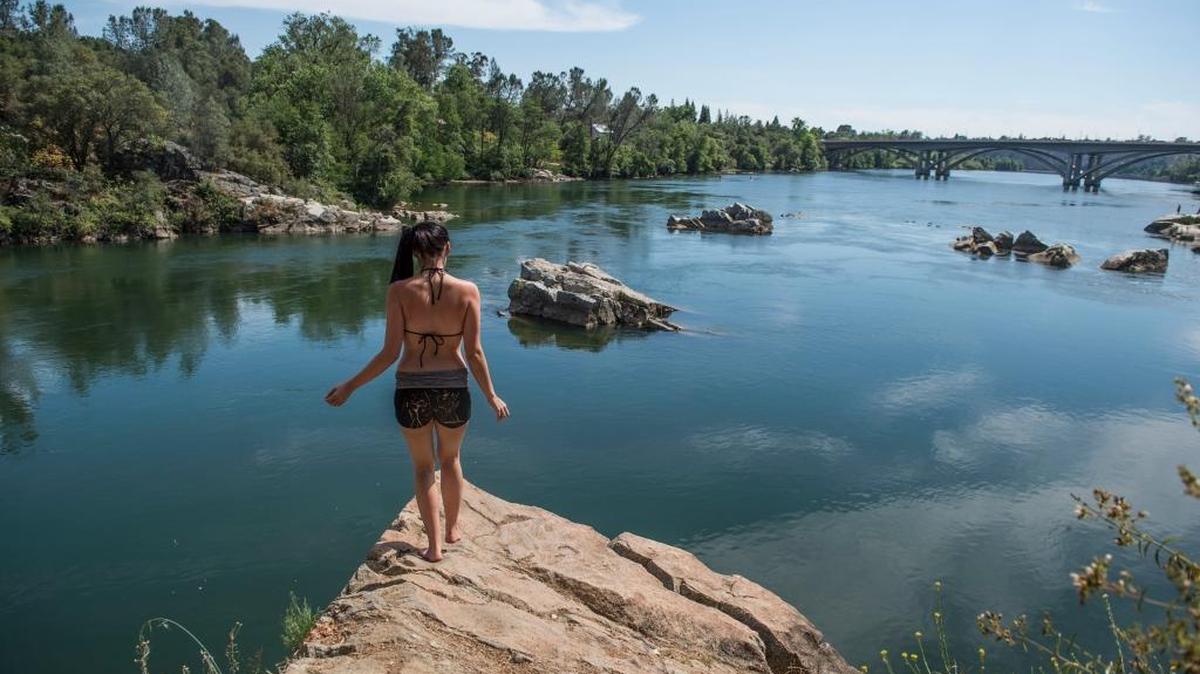 Katy Giudicessi, of Citrus Heights prepares to take a jump inside Lake Natoma in Folsom on Friday, June 3, 2016.