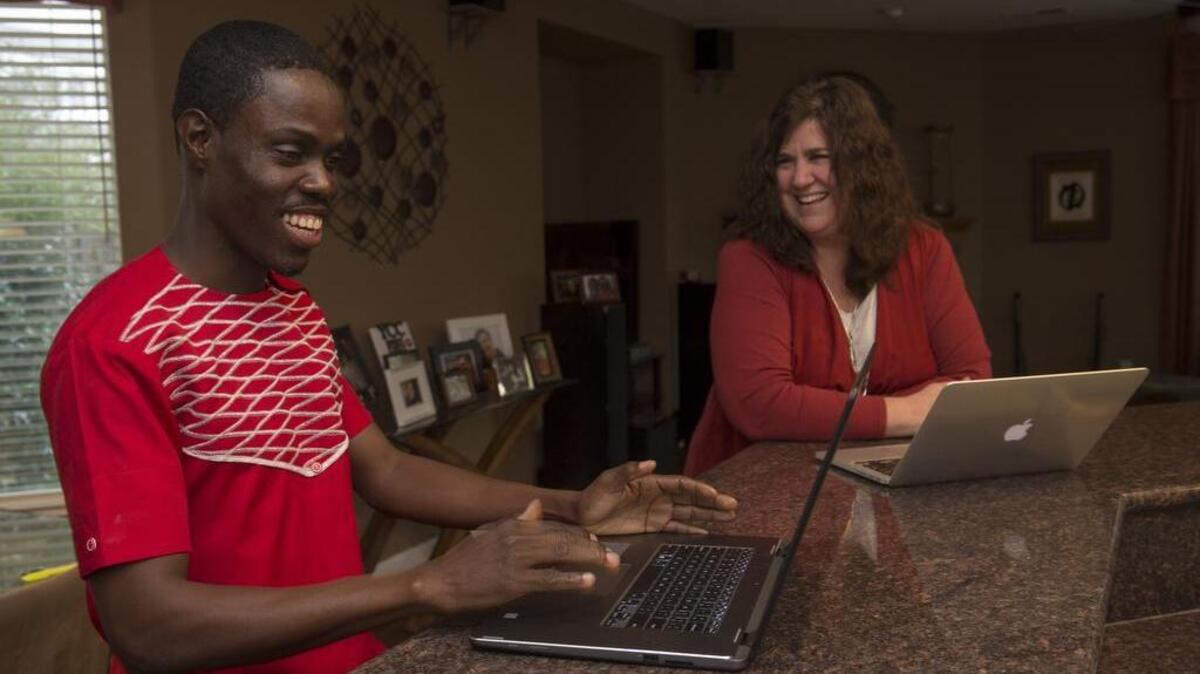Liberian liaison to the local nonprofit Raise Your Hand Foundation, Alexander Ireland, left, works in the kitchen of foundation founder, Shelley Spurlock in Roseville, Wednesday, December 1, 2016. The foundation helped supply money and medical supplies to Liberia during the Ebola epidemic.