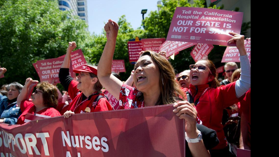 
Rida Villanueva, right, marches with hundreds of members of the California Nurses Association on Tuesday to the California Hospital Association headquarters and then on the Capitol, in part to protest the recent demise of the latest bill requiring nonprofit hospitals to better account for the charity care they provide.
