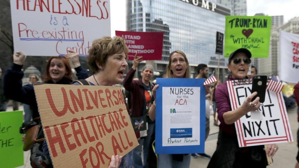 Protesters gather across the Chicago River from Trump Tower in March to rally against the repeal of the Affordable Care Act.