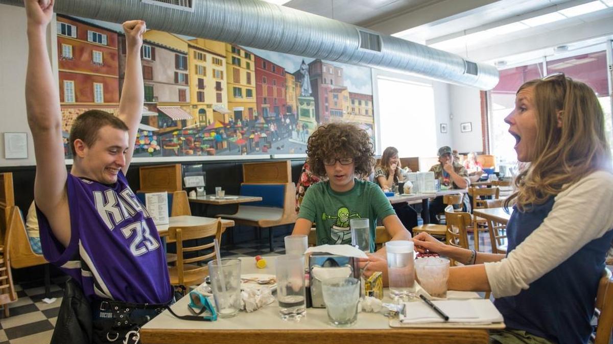 Carmichael therapist Kim Wagaman, right, has ice cream with Dustin Strasser, left, and Evan Roth in September. Both are in Wagaman’s social skills group designed for adults on the autistic spectrum.