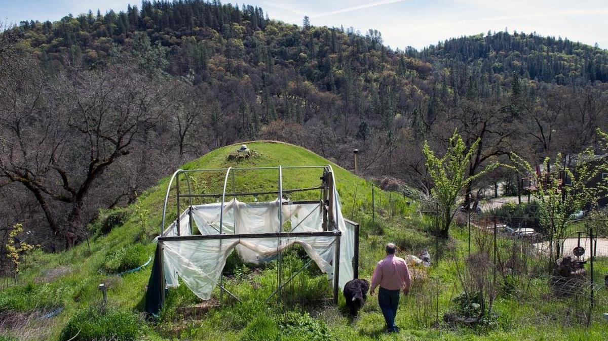 Brad Peceimer walks through a portion of his property raided by a sheriff’s team in 2014. He and other members of his medical marijuana collective say they have been unfairly targeted in the backlash against illicit pot activity in Nevada County.
