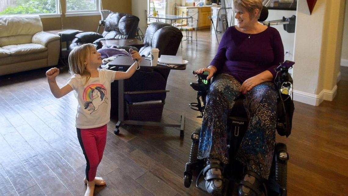 Shelly Hoover, right, watches her granddaughter Brynnlee Thomas, 4, dance at her home in Lincoln on April 6. Hoover is an ALS patient who plans to request an experimental drug as soon as it becomes available this summer. New California legislation, effective Jan. 1, gives patients with terminal illnesses access to drugs that haven’t been fully approved by the FDA.