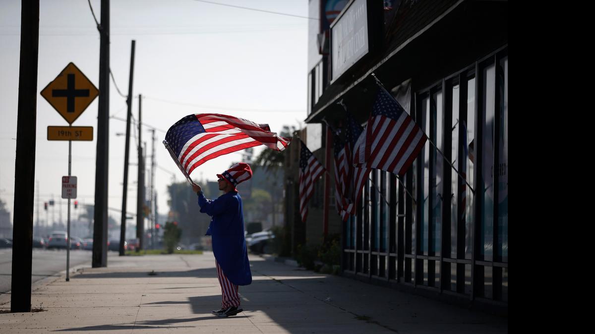 
Outside a health care enrollment center in Westminster, an “Uncle Sam” looks for insurance clients. The U.S. Supreme Court is deciding a major case on federal subsidies.

