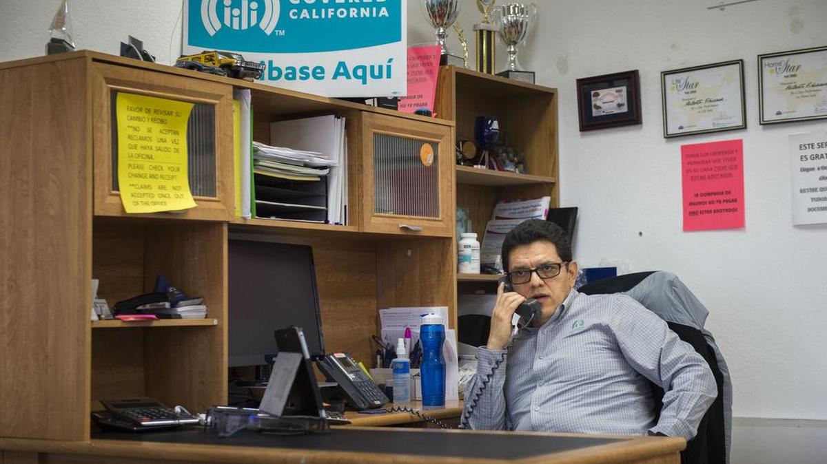 Albert Figueroa, a Farmers Insurance agent who sells Covered California health care policies, takes a phone call about about the insurance on Thursday, Jan. 26, 2017, at his office in Sacramento. Figueroa has seen a decline in customers subscribing to Covered California.