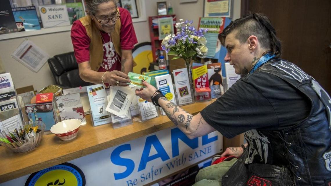 Hurley Merical, 69, left, gives Aliceon Beltrani, 39, a fentanyl test strip at SANE (Safer Alternatives through Networking & Education) in Sacramento on Wednesday, Feb. 14, 2018. She says she has used the strips three times and found one positive result.