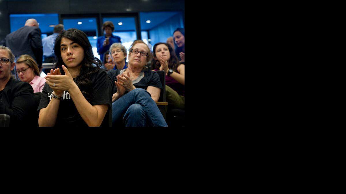 
Supporting the California Endowment’s Health4All campaign, Andrea Vega Torres applauds while listening Wednesday to a speaker during a workshop held by Sacramento County supervisors to consider options for restoring health care assistance to undocumented immigrants.
