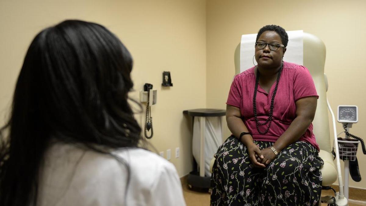 April Reding, right, talks with Oma Agbai a dermatologist for the UC Davis Health System, about a skin condition during an appointment, Tuesday, May 24, 2016. Agbai is starting a program for minority patients with race-specific skin problems, as well as promoting practices that increase sun protection.