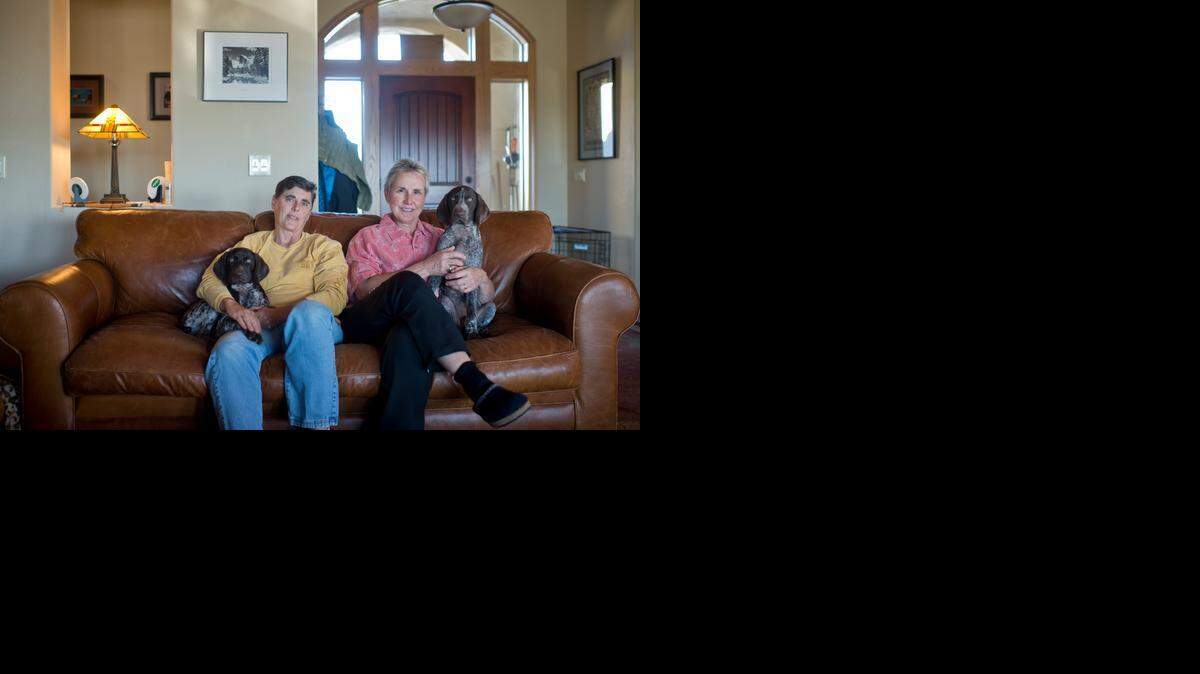 
San Francisco firefighters Casey McElheney and Karen Heald with their German short-haired pointer puppies Raven and Nahiku at their home in Davis,  are sitting on a couch with flame retardant chemicals.
