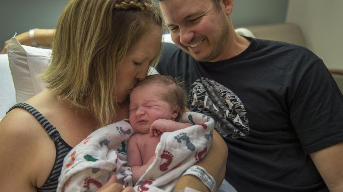 Newborn Beckett Mackey receives a loving kiss from mom Amanda Mackey as dad David Mackey smiles at Sutter Davis Hospital. “It was worth the drive for the experience,” said Amanda Mackey, a Rocklin resident, who delivered by natural child birth. Sutter Davis has the lowest C-section rate in the state.