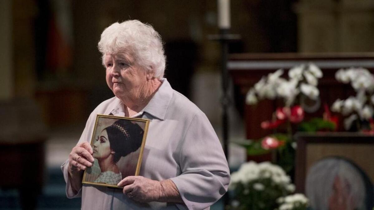 Sister Clare Graham hold a picture of her schoolmate Genevieve “Genny” Lucchesi while sharing stories about Lucchesi during her memorial at St Francis of Assisi church in Sacramento, Calif., on Friday, June 19, 2015. Lucchesi lived on the streets of Sacramento the past two decades and died on Feb. 11, 2015.