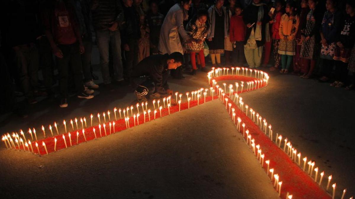 Nepalese women and children from a rehabilitation center for victims of sex trafficking light candles on the eve of World AIDS Day in Kathmandu, Nepal, Monday, Nov. 30, 2015. World AIDS Day is observed on December 1 every year to raise the awareness in the fight against HIV.