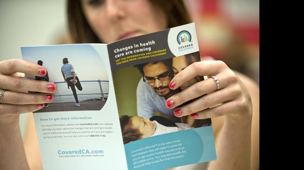 
Kristy Farrington, a Sacramento State student, looks at a pamphlet with information on Covered California. Under 2016 rates announced Monday by Covered California, Northern Californians will pay $88 more in average monthly health care premiums than Southern California consumers.
