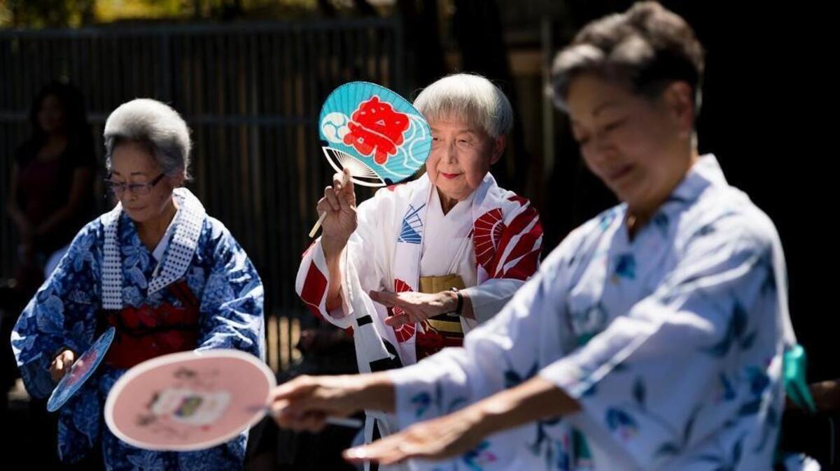 
Toshi Kawmura, center, leads the Sakura Minyo Dookoo Kai dance group during a rededication of the monument at Walerga Park on Tuesday in Sacramento. The Walerga Assembly Center held Japanese Americans from Sacramento and San Joaquin counties before they were sent to internment camps during World War II.
