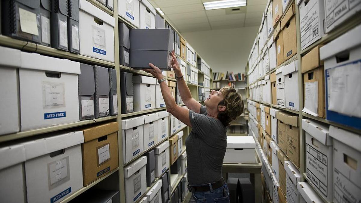 
Julie Thomas, special collections and manuscripts librarian at California State University, Sacramento, files an archival box of documents from the collection of Japanese incarceration documents, photographs and artifact archived at CSUS on Tuesday. The history of the incarceration of 120,000 Japanese Americans at 10 remote internment camps scattered across America during World War II will come to life online thanks to digital technology, Sacramento State announced.
