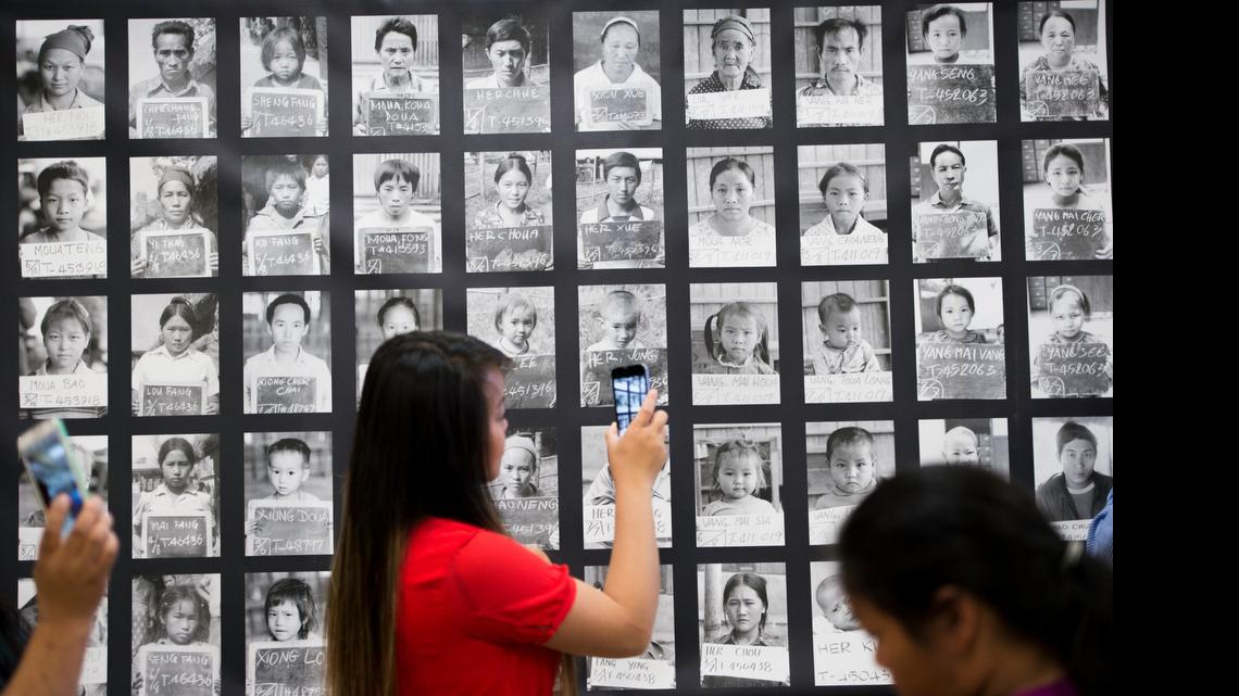 
Maika Xiong takes video of the identification photographs of Hmong refugees in the Thailand refugee camps at a preview of the “Hmong Story 40” project Sunday at Will C. Wood Middle School in Sacramento. The exhibit and photo gallery commemorates 40 years of Hmong people living in the United States.
