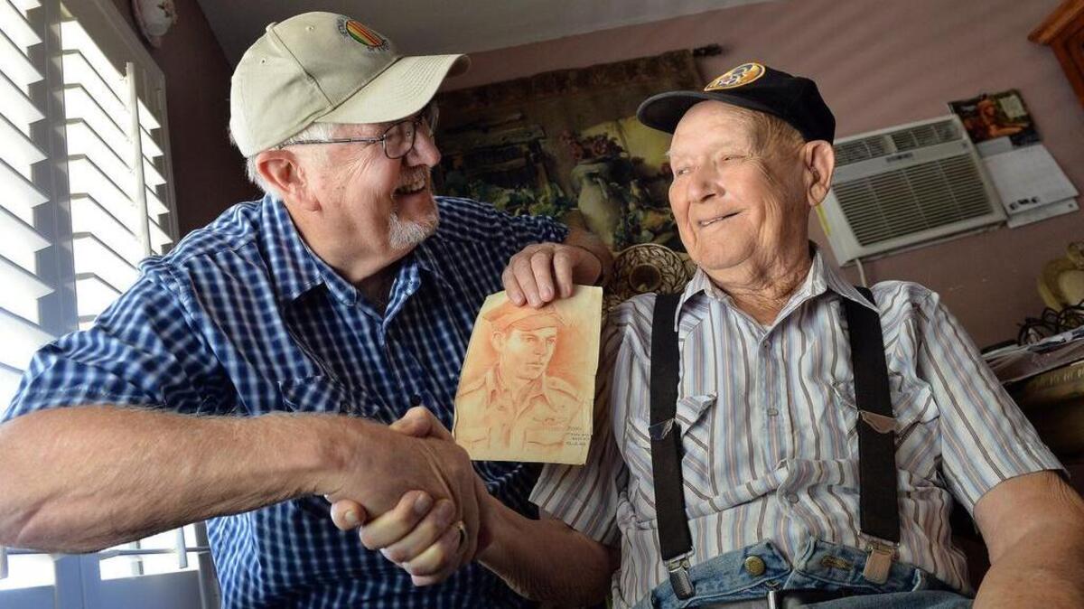 
Les Beck, 69, left, of Coarsegold, and Orville Lewis, 95, of Orange Cove share memories of Beck’s father, Lester Beck, pictured in the drawing, in Lewis’ home in Orange Cove. The two met by chance in mid-August in a VA waiting room and it turns out that Lewis knew Beck’s father, who died in 1995, from their time spent together in a POW camp in Austria during WWII.
