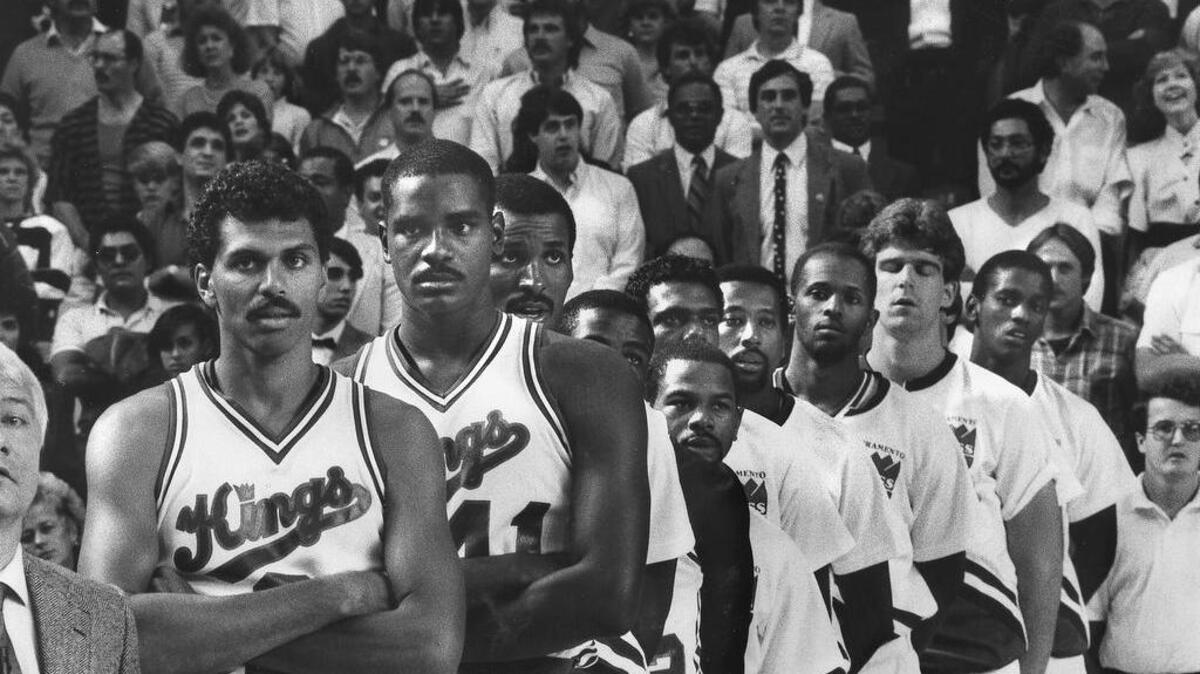 Members of the Sacramento Kings line up for the opening ceremonies for the first game for the franchise in Sacramento on Oct. 25, 1985. Players from left: Reggie Theus, LaSalle Thompson, Eddie Johnson, Larry Drew, Michael Adams, Carl Henry, Mike Woodson, David Cooke, Joe Kleine and Otis Thorpe.