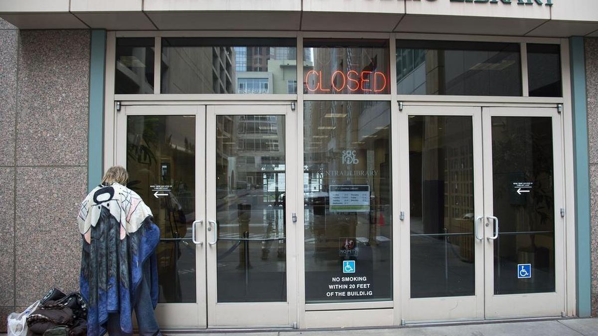 A homeless man waits for the downtown library doors to open on Jan. 26, 2017. Librarians and other staff members are receiving training to help them understand and deal with mental illness, which affects many more homeless people than others according to studies.
